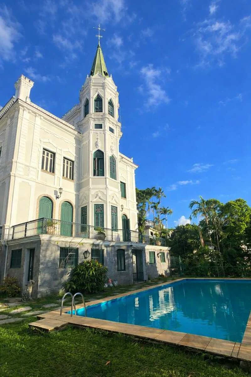 The white castle façade beside the pool