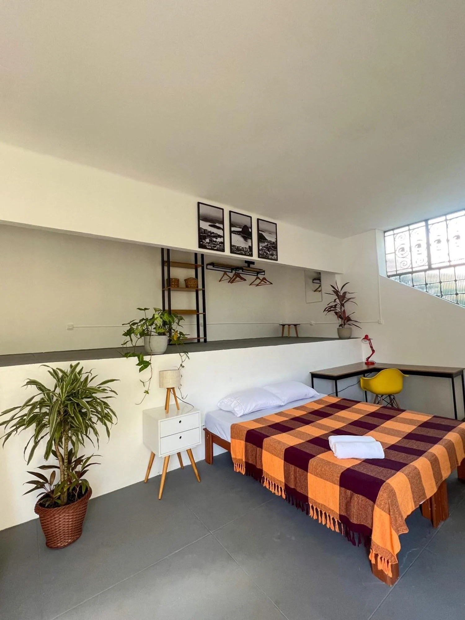 A private room with a double bed and desk area